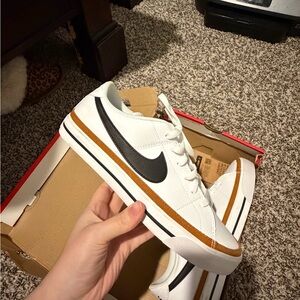 Nike White Sneakers with Black Swoosh and Brown Stripe